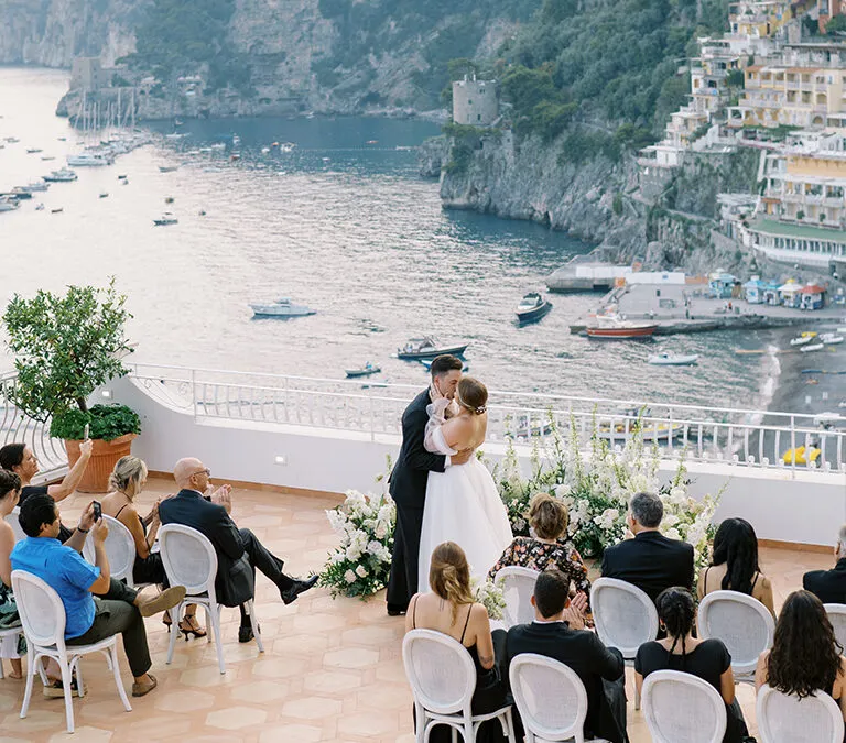 An alluring floral-filled Spring rooftop wedding in Positano with live painter